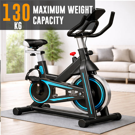 Black and blue exercise bike with maximum weight capacity text in a home setting