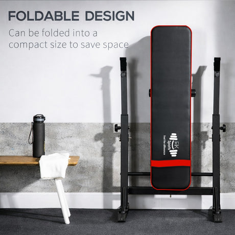 Foldable gym bench with black and red design on a gray floor.